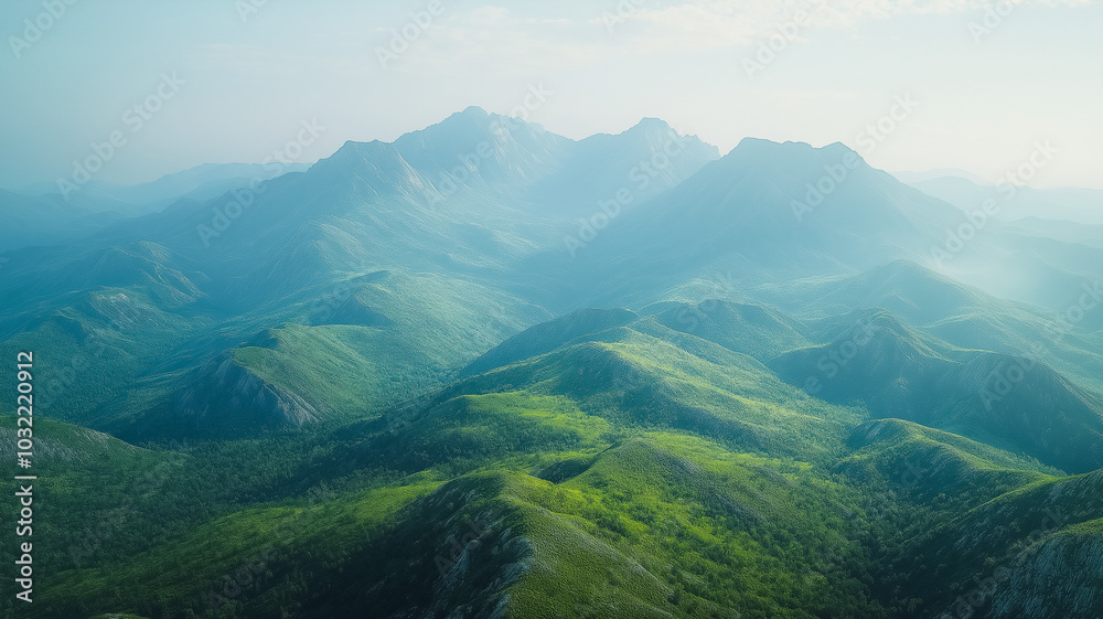 Obraz premium The mountains are covered in lush green trees and the sky is clear and blue. The scene is peaceful and serene, with the mountains providing a beautiful backdrop