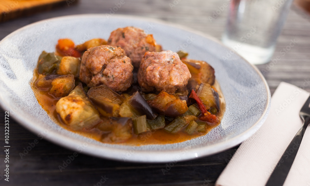 Cooked meatballs with stewed eggplant with haze in bowl Cooked meatballs with stewed eggplant with haze in bowl