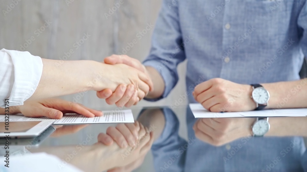 Unrecognizable business people clapping over glass table after contract signing in office. Agreement and handshake themes Unrecognizable business people clapping over glass table after contract signing in office. Agreement and handshake themes