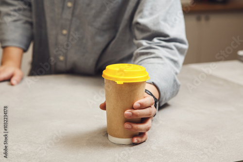 Barista Serving Freshly Brewed Takeaway Coffee at Modern Coffee Shop Counter photo