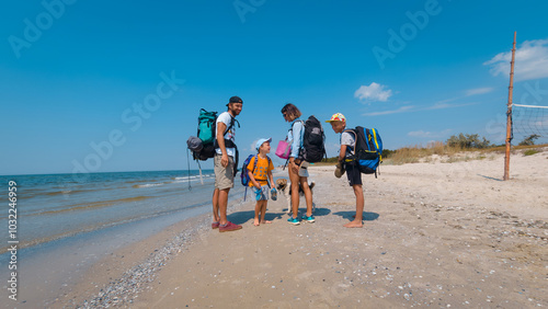 Happy Family with Backpacks Ready for a Beachside Hike