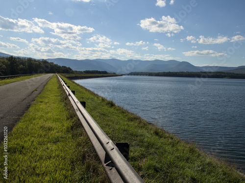 steel beam rail road divider on ashokan reservoir promenade walking biking pedestrian leisure trail path in hudson valley upstate new york (catskills mountains background) scenic leisure park travel photo