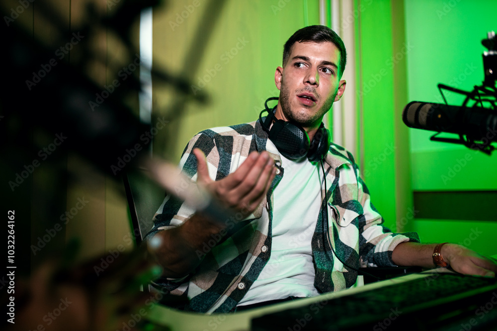 Male podcaster making podcast with young woman from his studio.