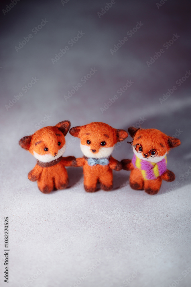 Handicraft hobby concept felting children's toys. Soft toy red fox with a warm scarf. Hobbies to improve psychological well-being. Handicraft hobby concept felting children's toys. Soft toy red fox with a warm scarf. Hobbies to improve psychological well-being.