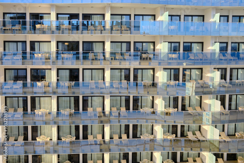 A modern building with multiple balconies and glass railings, offering a contemporary architectural perspective.