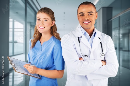 Portrait of two doctors smiling standing in medical consultation.