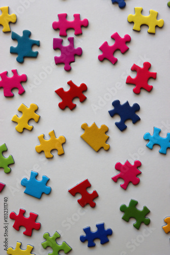 Colorful jigsaw puzzle pieces on white background. Flat lay.