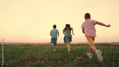 Happy childhood. Teenagers play running. Funny children play in park, friends run in summer. Child run on grass, sunset. Happy boy, girl run in field, playing in nature. Family, weekend outdoors.