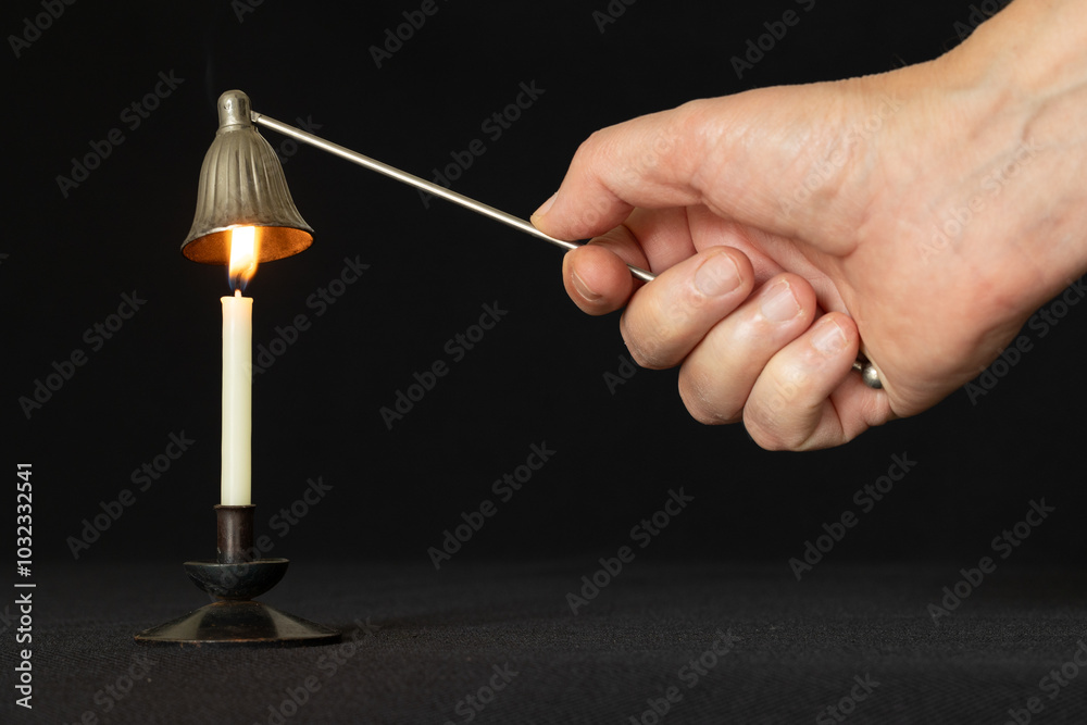 Candle snuffer using to extinguish burning candle Candle snuffer using to extinguish burning candle