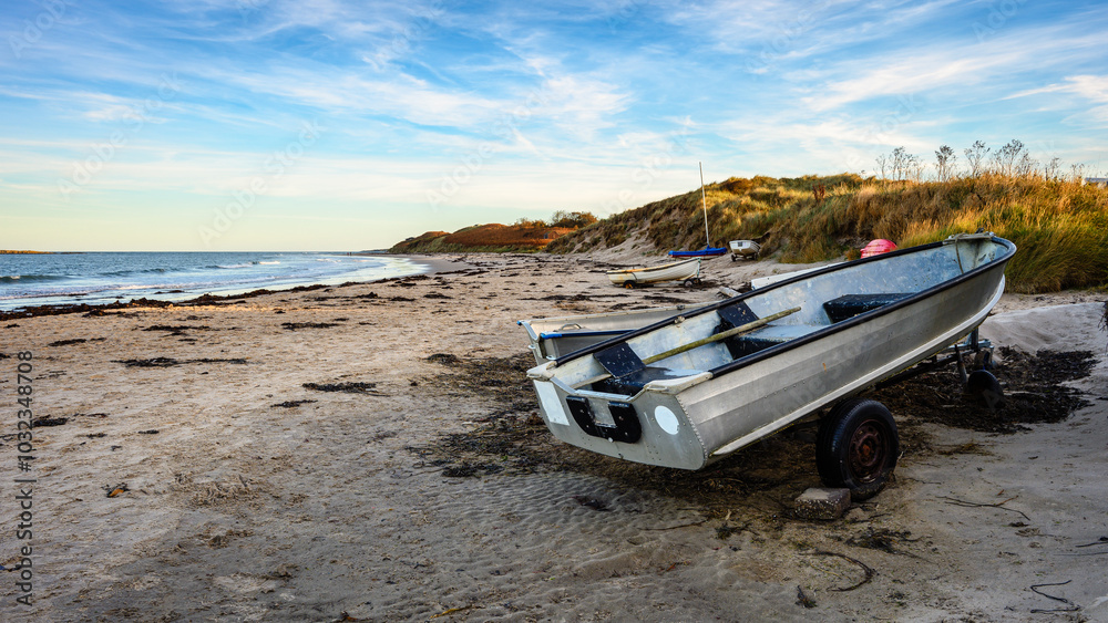 Boats on Low Newton Sandy Beach, also known as Low Newton-by-the-sea it is a small fishing village on the North Sea coastline in Northumberland's AONB or National Landscape as it's been renamed