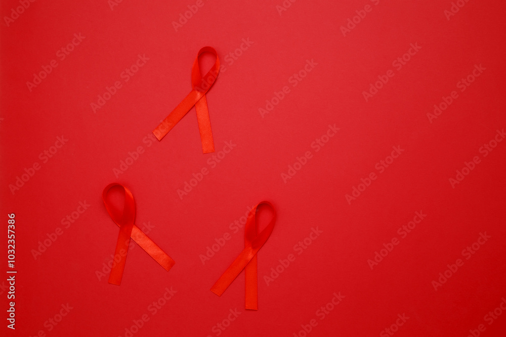 Red ribbons with awareness about AIDS on a red background. World AIDS Day Red ribbons with awareness about AIDS on a red background. World AIDS Day
