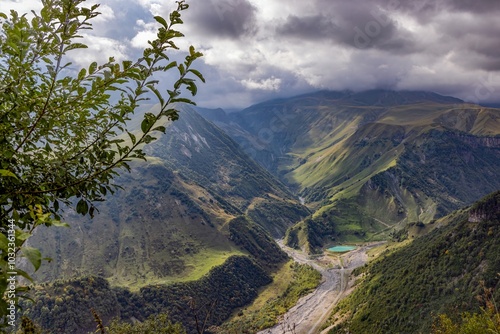 Scenic view of the Cross Pass in Georgia, showcasing lush green mountains and a winding valley photo