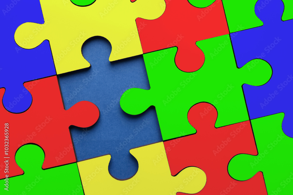 Many colorful puzzle pieces on blue background, top view. Symbol of autism Many colorful puzzle pieces on blue background, top view. Symbol of autism