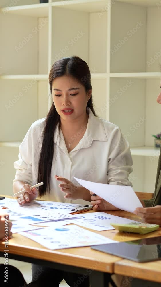 Focused woman in white shirt engages in business analysis during meeting, reviewing documents with strong emphasis on teamwork and collaboration, showcasing her professional dedication. Focused woman in white shirt engages in business analysis during meeting, reviewing documents with strong emphasis on teamwork and collaboration, showcasing her professional dedication.