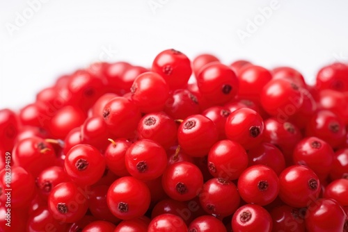 A detailed macro shot of cowberries, focusing on their smooth skin and vibrant red color, against a white background that enhances their natural beauty