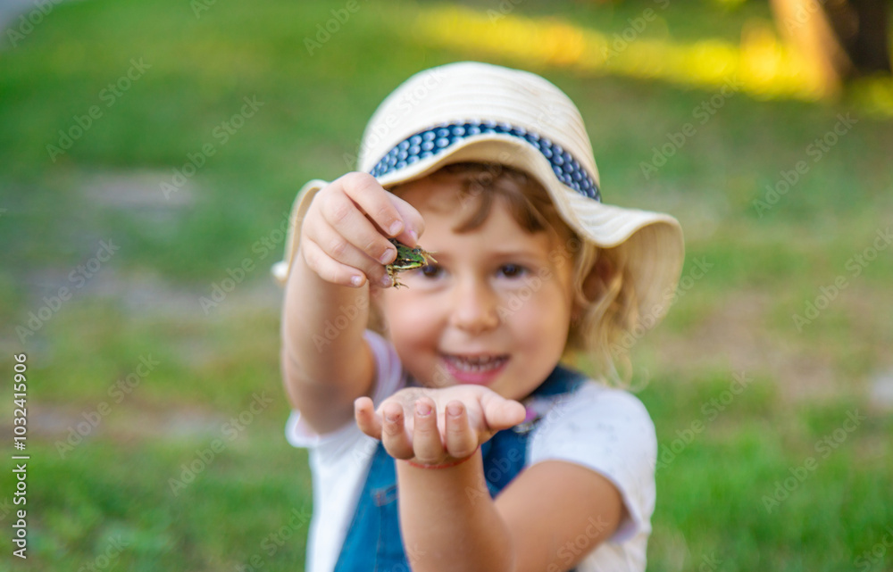 A child looks through a magnifying glass in nature. Selective focus. A child looks through a magnifying glass in nature. Selective focus.