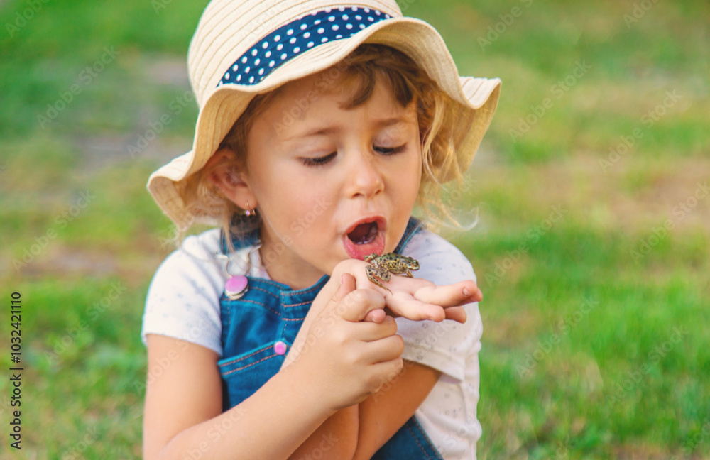 A child looks through a magnifying glass in nature. Selective focus. A child looks through a magnifying glass in nature. Selective focus.