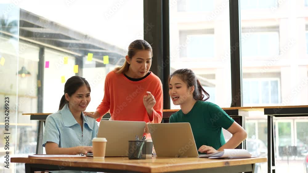 Bright and Modern Workspace Women Engaging in Teamwork, Collaboration, and Discussion Over Coffee While Sharing Ideas on Laptops Bright and Modern Workspace Women Engaging in Teamwork, Collaboration, and Discussion Over Coffee While Sharing Ideas on Laptops