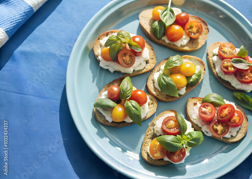 Overhead shot of crispy wheat crostini arranged on a plate, each topped with vibrant tomatoes and fresh basil photo