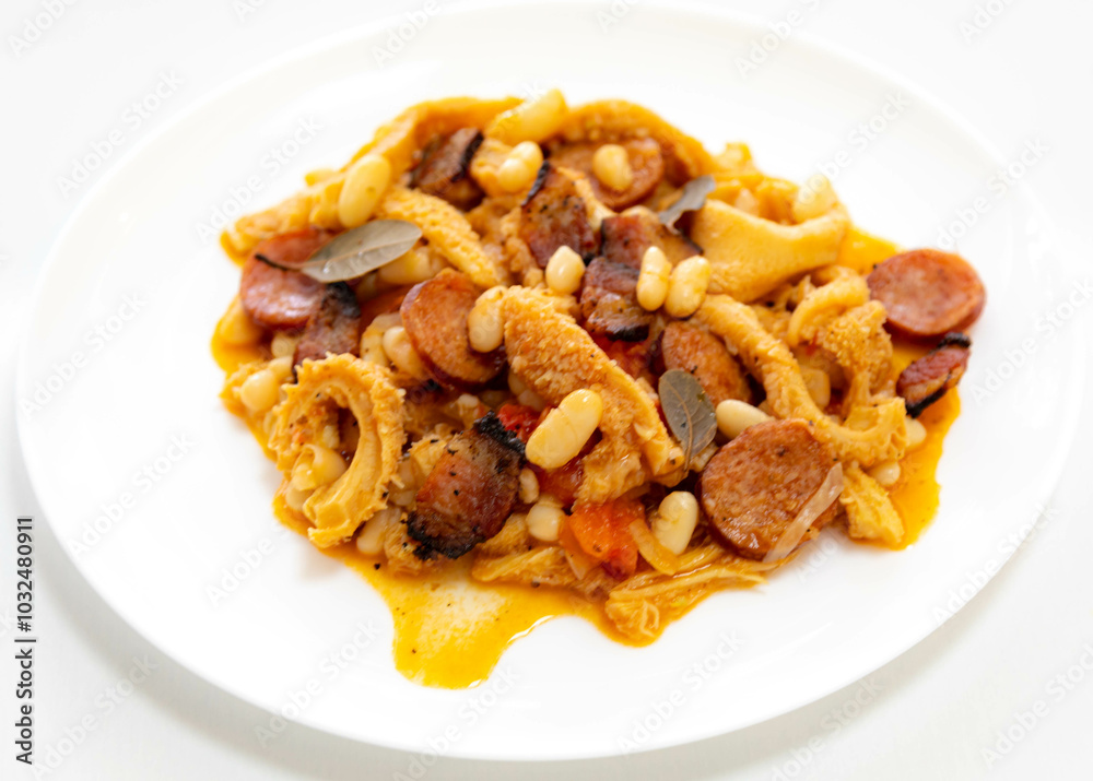 Beef tripe (bucho), beef stomach, tripe on a white plate. Dobradinha Beef tripe (bucho), beef stomach, tripe on a white plate. Dobradinha