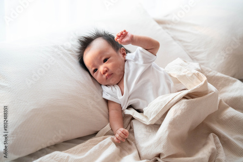 Baby Relaxing on Bed in Soft Morning Light