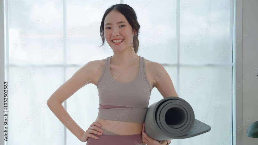 Asian woman holding yoga mat after workout. Health and fitness concept. Exercise.
Asian woman holding yoga mat after workout. Health and fitness concept. Exercise.