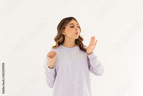 Young caucasian woman looking at manicure on white background