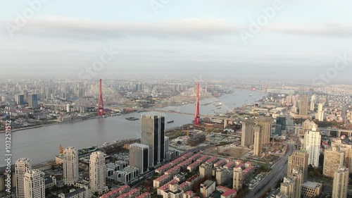 Aerial view of Yangpu Bridge with Shanghai cityscape under a gray sky photo