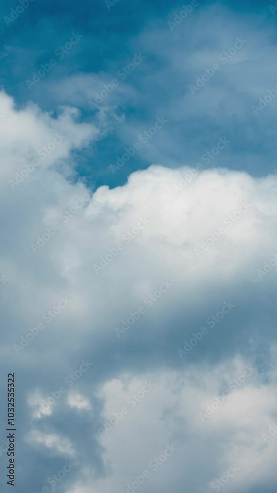 Vertical video - Timelapse of white puffy clouds in the blue sky Vertical video - Timelapse of white puffy clouds in the blue sky