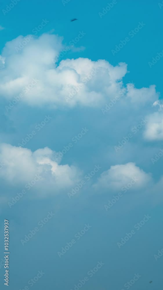 Vertical video - Timelapse of white puffy clouds in the blue sky Vertical video - Timelapse of white puffy clouds in the blue sky