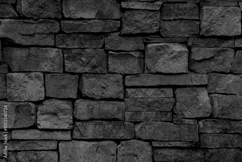 The black wall is made of stone and it is very thick.