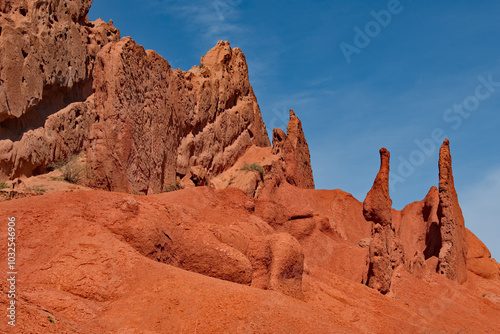 Northern Kyrgyzstan. Picturesque views of the famous Skazka Canyon, the clay mountain peaks of which have bright colors from yellow to red-brown.