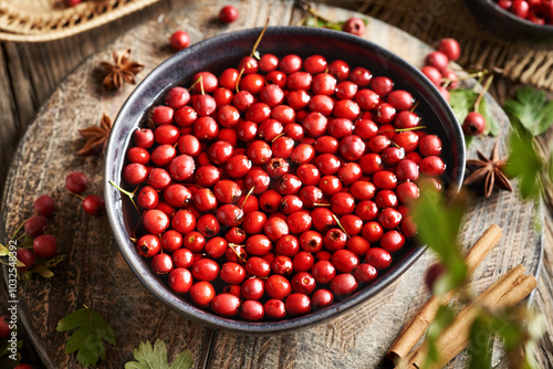 Preparing medicinal wine from wild hawthorn berries harvested in autumn, cinnamon and spices photo