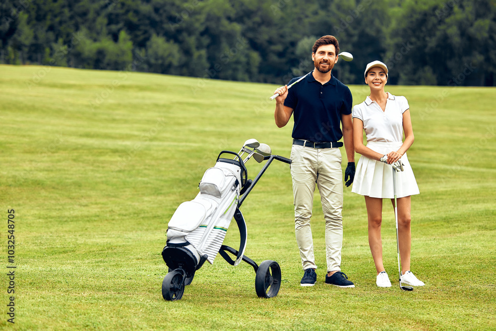 Obraz premium A Loving Couple Enjoying a Leisurely Stroll with Their Baby Stroller in a Lush Green Field