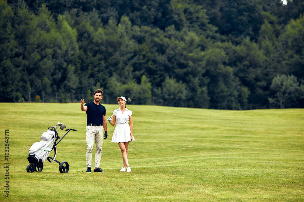 A Loving Couple Enjoying a Leisurely Stroll with Their Baby Stroller in a Lush Green Field A Loving Couple Enjoying a Leisurely Stroll with Their Baby Stroller in a Lush Green Field