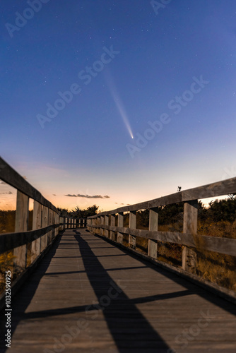 Comet C 2023 A3 (Tsuchinshan–ATLAS) setting over a wooden boardwalk. Robert Moses State Park, Fire Island New York