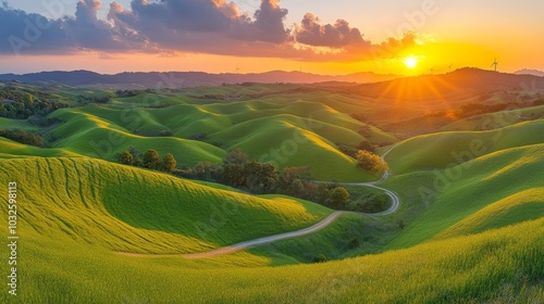 Una vista panorámica de colinas verdes con un camino serpenteante, iluminadas por los últimos rayos del sol en el horizonte.
 photo