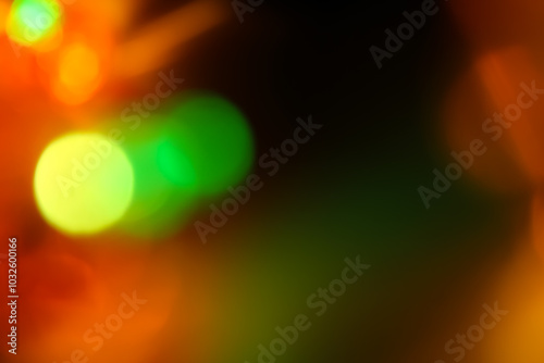 Dark background with green orange bokeh