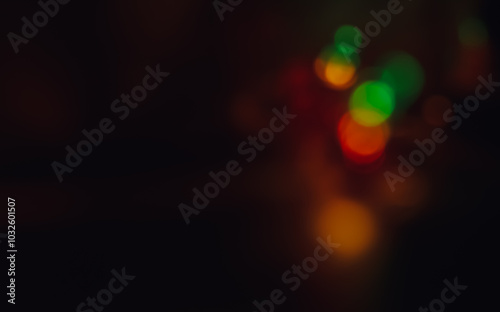 Dark background with multi-colored bokeh of different sizes