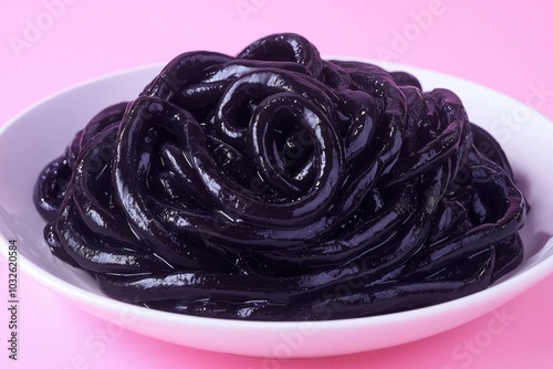 Black Jelly Dessert in a White Bowl on a Pink Background