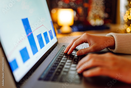 Close-up image of a woman hand working and typing on laptop computer keyboard. Online work during holidays. Business, Freelance, Shopping, education. photo