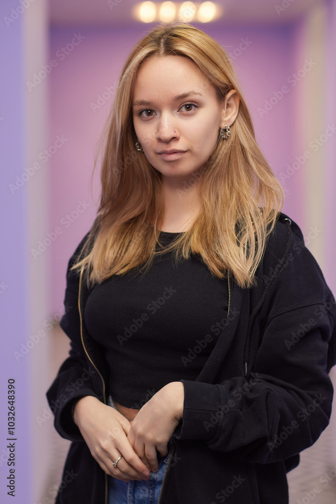 Closeup of a young woman's visage with piercing hanging from her nose. Closeup of a young woman's visage with piercing hanging from her nose.