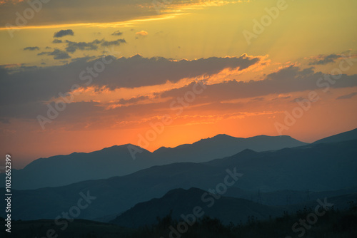 Beautiful sunset over the mountains in the summer. photo