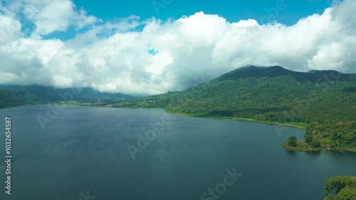 Wallpaper Mural Aerial view of Twin Lakes Buyan and Tamblingan with lush green hills, a vibrant blue sky, and fluffy clouds. Torontodigital.ca