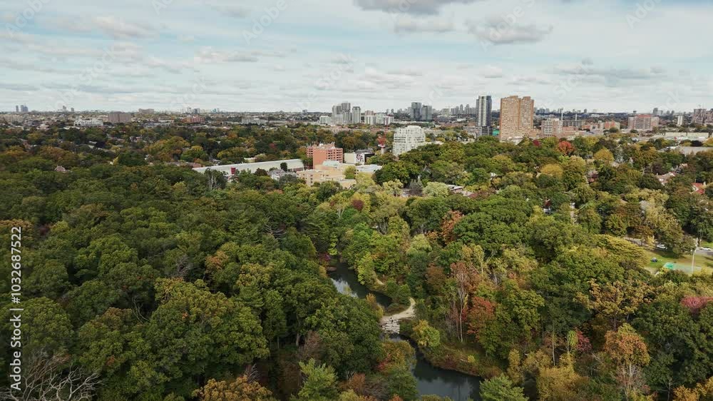 Stunning wide-angle shot of Toronto skyline in early fall, showcasing beautiful autumn foliage colors. Perfect for travel promotions and seasonal cityscape footage Stunning wide-angle shot of Toronto skyline in early fall, showcasing beautiful autumn foliage colors. Perfect for travel promotions and seasonal cityscape footage