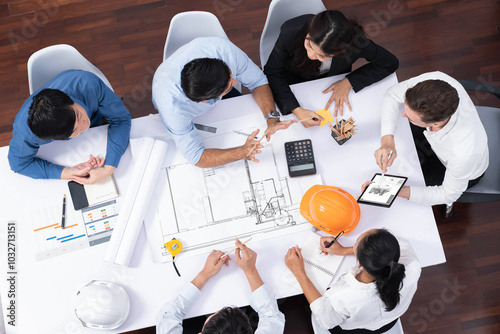 Top view banner of diverse group of civil engineer and client working together on architectural project, reviewing construction plan and building blueprint at meeting table. Prudent