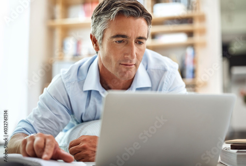 Man thinking, laptop and worker in office on floor, research and website for startup proposal. Male person, brainstorming and book for business project idea, professional perspective and solution