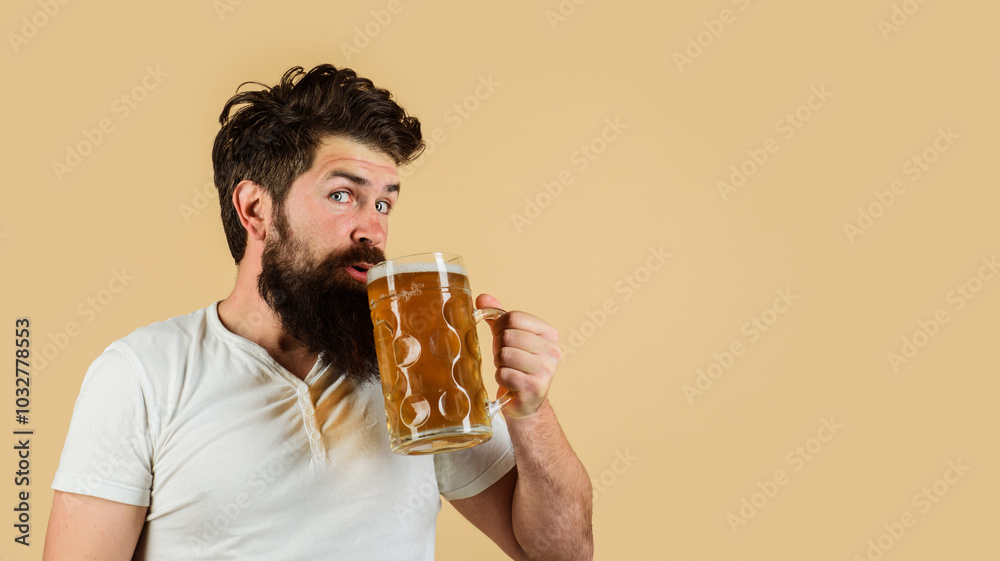 Beer pub or bar. Bearded man drinking delicious lager beer at restaurant. Beer in Germany. Handsome male in casual wear with mug of fresh brewed beer. Alcohol and leisure. Copy space for advertising. Beer pub or bar. Bearded man drinking delicious lager beer at restaurant. Beer in Germany. Handsome male in casual wear with mug of fresh brewed beer. Alcohol and leisure. Copy space for advertising.