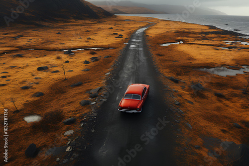 Red car driving on remote scenic road with beautiful Iceland landscape, aerial view photo