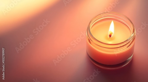 A single burning candle in a glass jar on a soft pink background with warm light and shadows.